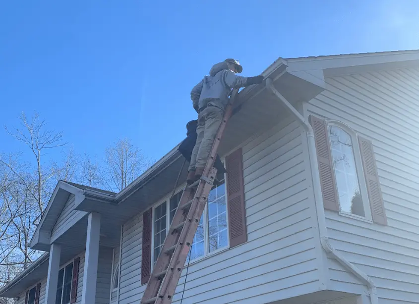 Gutter cleaning and maintenance being performed by Aurora Power Washing in Aurora